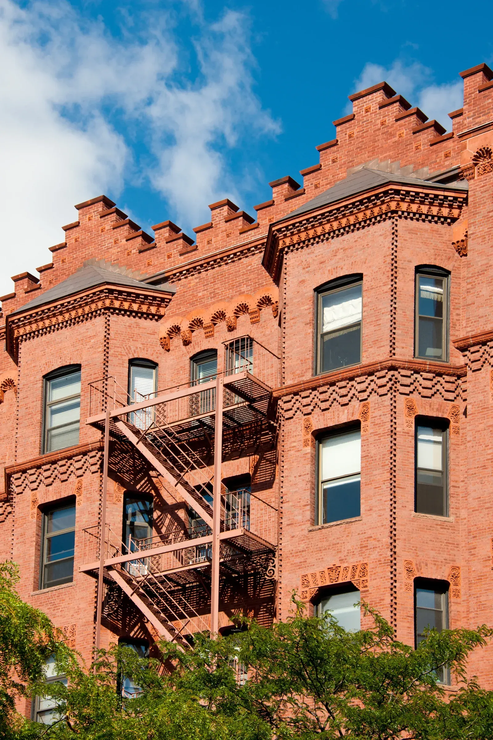 Historic brick facade with fire escapes after restoration